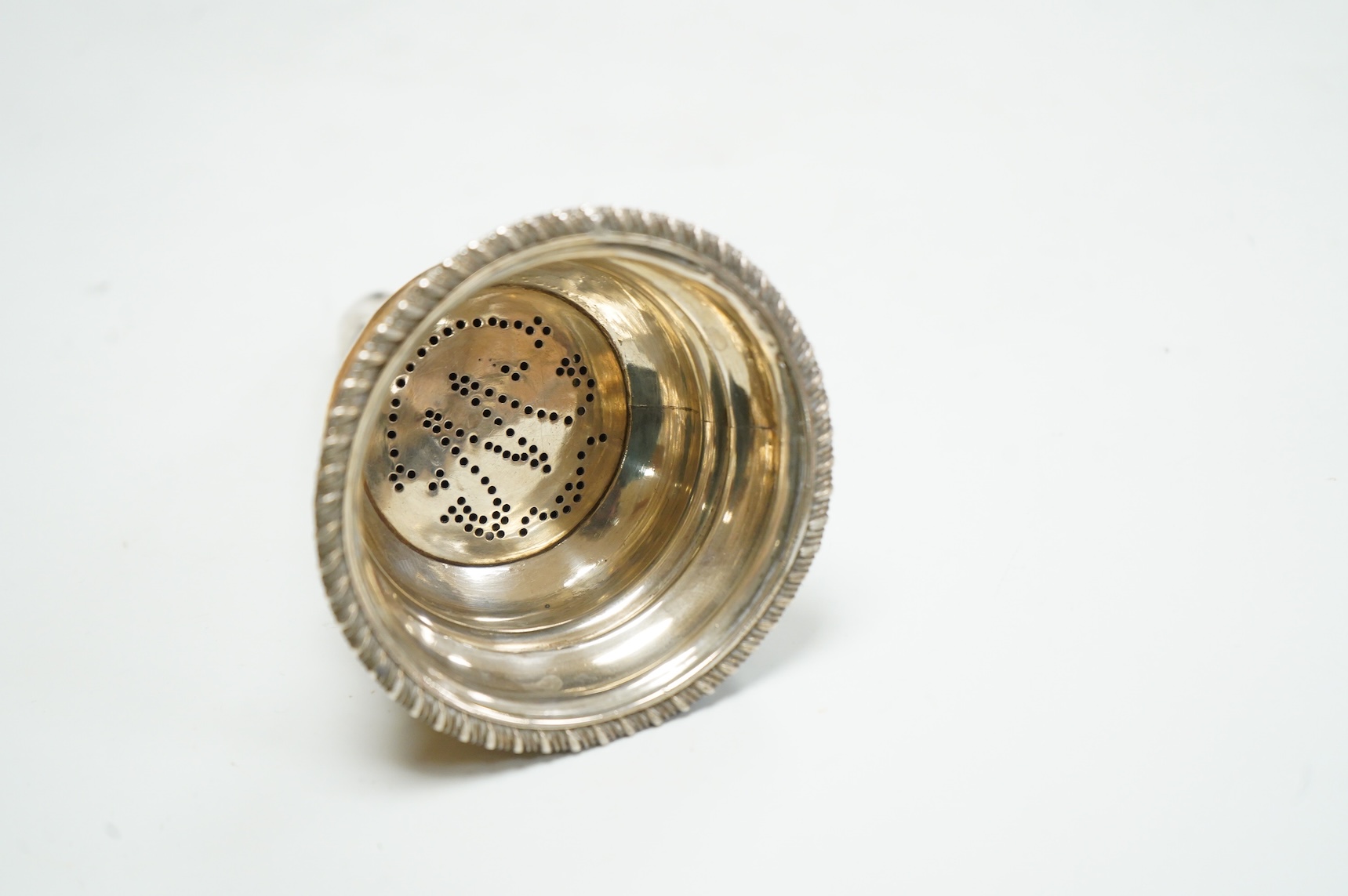 A George III silver wine funnel, with shell thumbpiece, marks rubbed, 14.5cm.